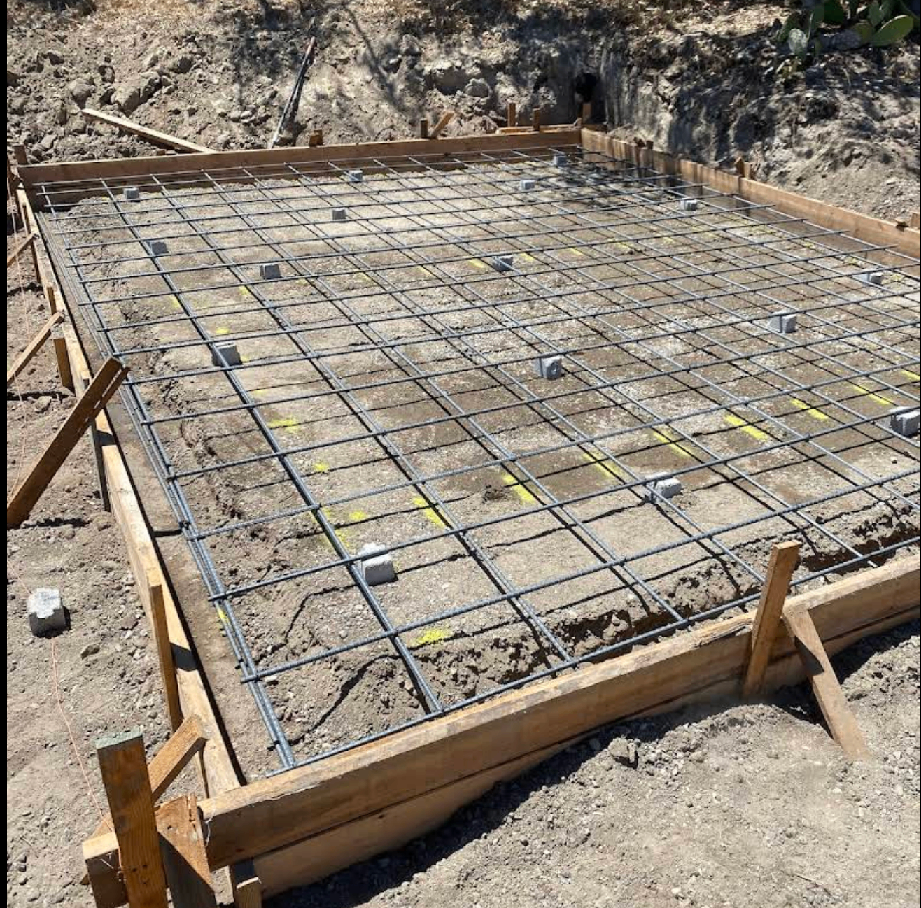 Reinforced concrete foundation slab with rebar set by Central Coast contractor